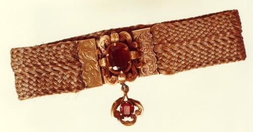 A replica of Charlotte Brontë’s hairwork and garnet memorial bracelet, woven with Anne and Emily’s hair.