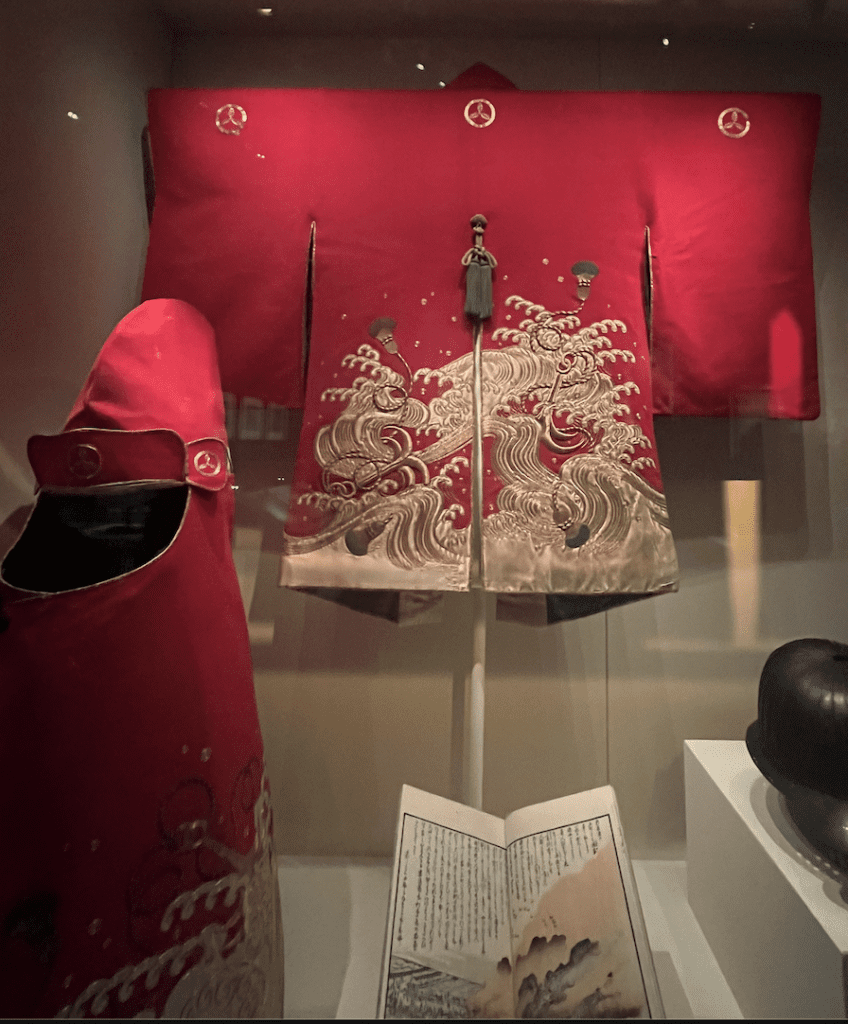 A firefighting jacket and hood worn by a female firefighter on display at the British Museum. Photograph by Ashley Innes.