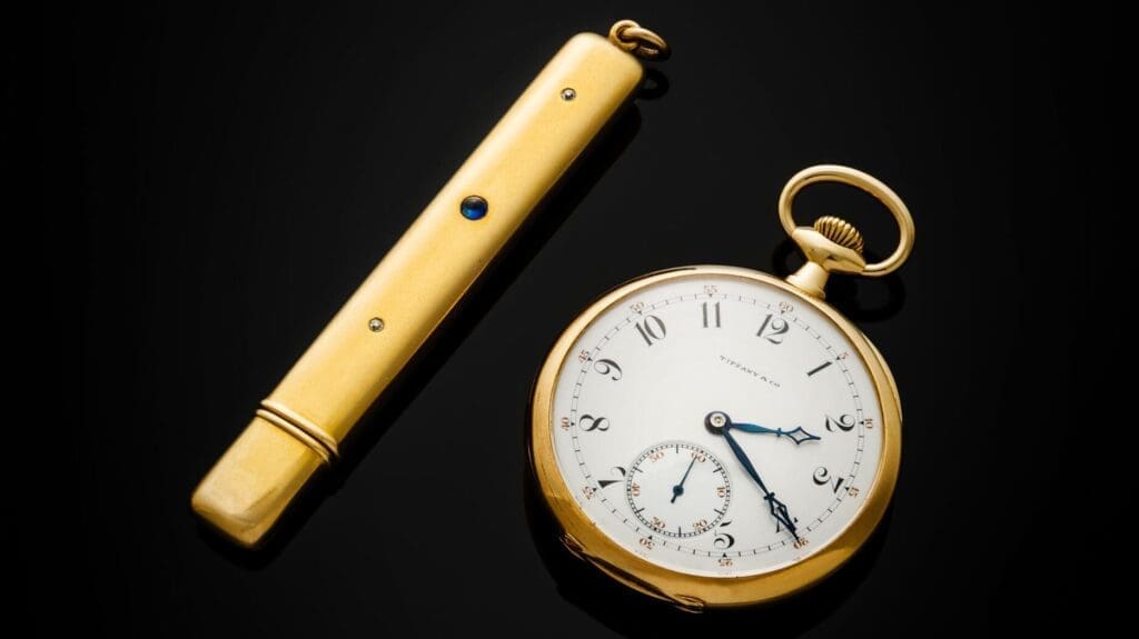 The Astor pocketwatch and a gold, diamond and sapphire pencil case.
